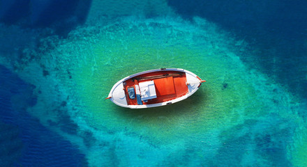 Aerial drone top down photo of traditional wooden fishing boat docked in Zakynthos island, Ionian, Greece - obrazy, fototapety, plakaty