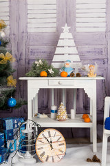 New Year's interior room. Christmas tree decorated with colorful balloons and gifts lie on the floor. Christmas and New Year background.