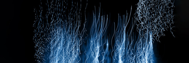 Photos on a long exposure. Pattern from the fireworks in the night sky tinted in blue.