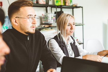 A team of young businessmen working and communicating together in an office. Corporate businessteam and manager in a meeting.