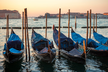 Fototapeta na wymiar Gondolas by Saint Mark square at sunrise, Venice, Italy