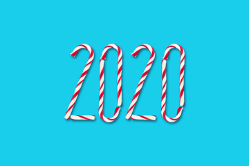 2020. Composed of Christmas candies on a blue background. Christmas background