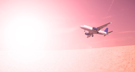 The plane over the desert at sunset in the evening. Scenery transport.