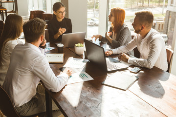 A team of young businessmen working and communicating together in an office. Corporate businessteam...