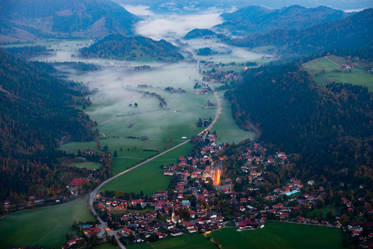 Bayrischzell municipality aerial view, with a view of Osterhofen town between the fog on Alpen road 307. German beautiful nature and green forests, Bavaria, Germany
