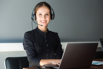 Portrait of woman customer service worker, call center smiling operator with phone on office