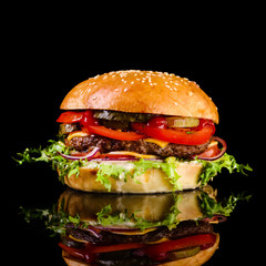 fast food juicy burger on a black background