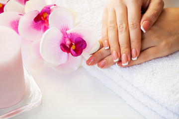 Obraz na płótnie Canvas Nails care. Beautiful woman's nails with french manicure, in beauty studio