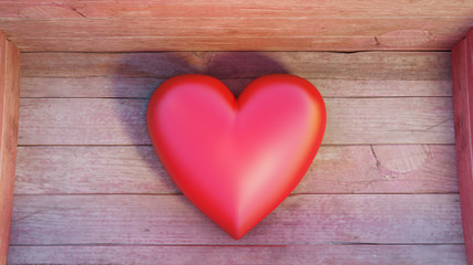 Close-up of a very big and chubby red heart put into a wood box