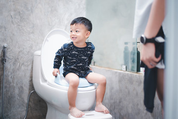 baby are training to sit in the toilet.
