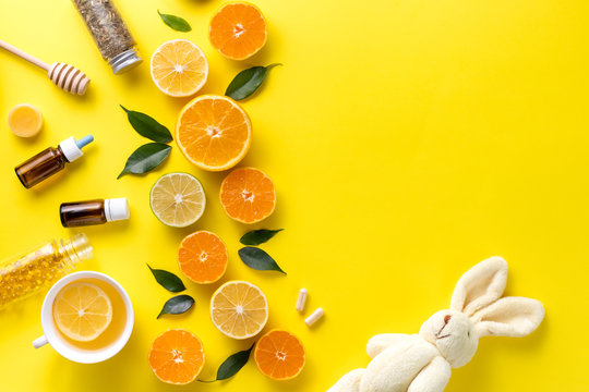 Illness concept. Composition alternative medicine. Herbal tea, ginger and lemon on a yellow background. Child's health. Flat lay. View from above. Copy space
