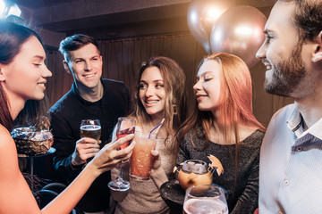 group of young people together in karaoke bar, singing and having fun together, clubbers rocking and chilling out in karaoke. celebration, holiday, birthday concept
