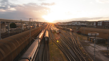 Fototapeta na wymiar Train station in sunset with trains and rails