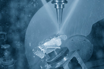 The 5-axis CNC milling machine  cutting the sample of aluminium  parts by solid ball endmill tools. The automotive parts manufacturing process by 5-axis machining center.