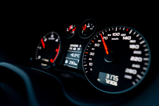 Close up shot of a speedometer in a car. Car dashboard. Dashboard details with indication lamps.Car instrument panel. Dashboard with speedometer, tachometer, odometer. Car detailing.