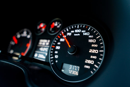 Close up shot of a speedometer in a car. Car dashboard. Dashboard details with indication lamps.Car instrument panel. Dashboard with speedometer, tachometer, odometer. Car detailing. - Powered by Adobe