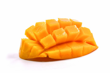 An isolated mango partially sliced into cubes.