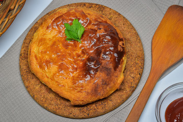 An Australian meat pie on a white background. Top view.