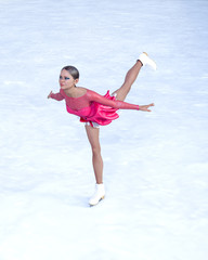 Fototapeta premium Young beautiful girl ice skating.