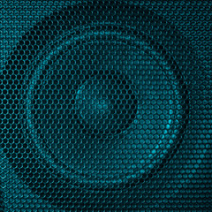 A close up macro photo of a speaker lit with a vibrant turquoise aqua teal flash gel