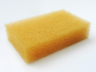 High angle view of orange scouring sponge isolated on white background. Cleaning and cleaning tool.