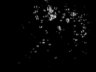 White bubbles on a black background. White bokeh. Black and white images.