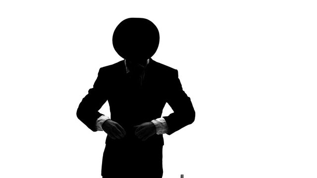 Silhouette Elegant man in a black hat is dancing an erotic dance. He uses a chair and a cigarette. White background. Close up, slow motion.