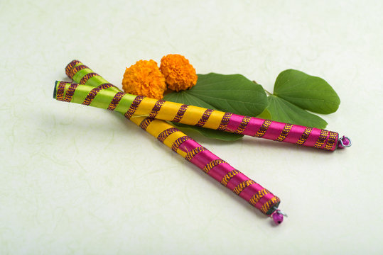 Indian Festival Dussehra, showing golden leaf (Bauhinia racemosa) and marigold flowers with Dandiya sticks.