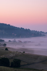 Sunrise on the mountain with morning fog in the valley.