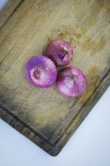 Fresh organic Onion on wooden background.