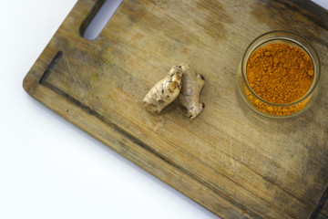 Fresh organic, ginger with turmeric in a bowl on wooden background.