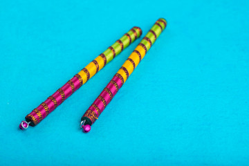 Dandiya sticks on a blue background. Raas Garba or Dandiya Raas is the traditional folk dance form...
