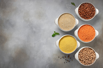 Fototapeta na wymiar different raw cereals: couscous, beans, quinoa, lentils, chickpeas. spices, herbs, salt. copy space, top view, horizontal image