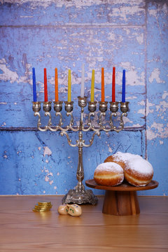 hanukkah menorah candles  blue wood background