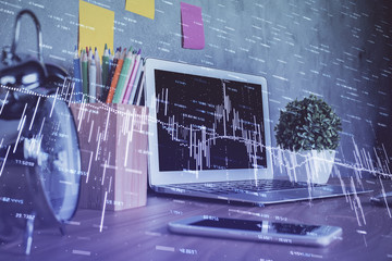 Financial graph colorful drawing and table with computer on background. Double exposure. Concept of international markets.