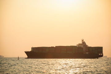 Fototapeta premium A cargo ship at sea in the evening