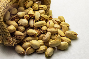 A bunch of pistachios poured out of the little bag.