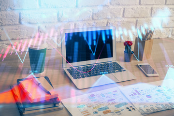 Financial chart drawing and table with computer on background. Double exposure. Concept of international markets.