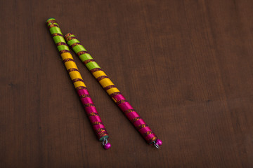 Dandiya sticks on a brown background. Raas Garba or Dandiya Raas is the traditional folk dance form...