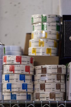 rools of colored labels on shelf in warehouse