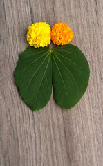 Indian Festival Dussehra, showing golden leaf (Bauhinia racemosa) and marigold flowers on a wooden...