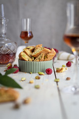 biscotti - italian cookies with pistachios, raspberries, a glass of brandy