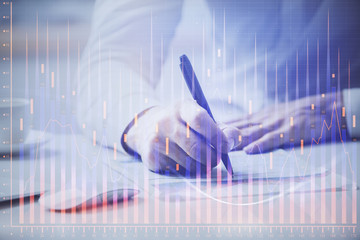 Fototapeta na wymiar Financial trading chart multi exposure with man desktop background.