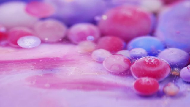 Bright collors bubbles moves in slow motion in oil with acrylic