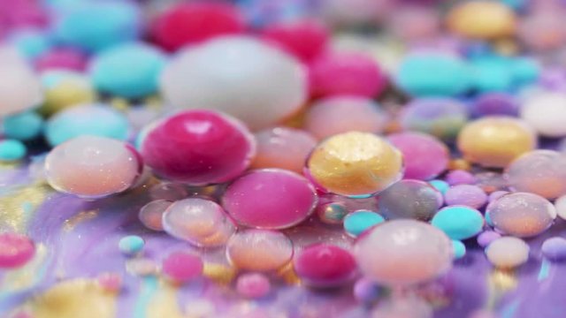 Bright collors bubbles moves in slow motion in oil with acrylic