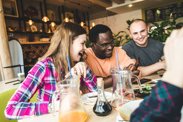 Meet young attractive people in the cafe. Friends chat, have fun, drink cocktails and eat