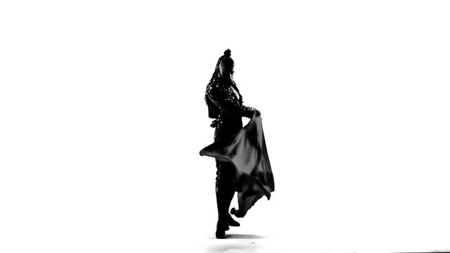 Silhouette Dancing man wearing a toreador costume. Isolated on white background in full length. Close up, slow motion.