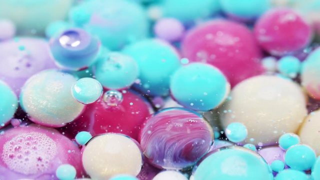 Bright collors bubbles moves in slow motion in oil with acrylic