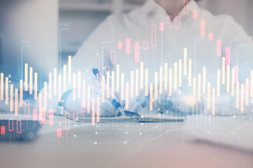 Financial chart drawn over hands taking notes background. Concept of research. Multi exposure