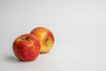 Two bright red apples on white background, healthy fruit concept and weight loss